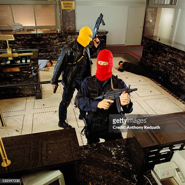 armed men robbing bank - bank robber stock pictures, royalty-free photos & images