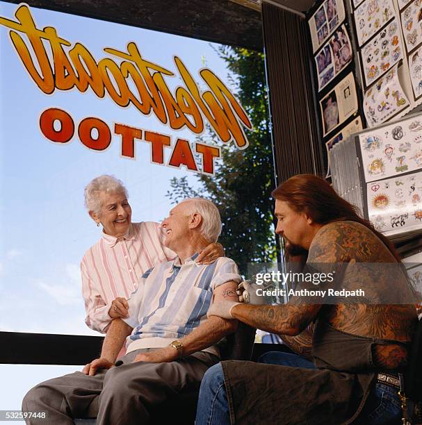 senior man getting tattoo - tattooing ストックフォトと画像