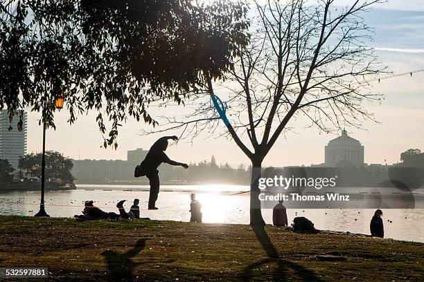 man balancing on a rope at lake merritt - oakland california stock pictures, royalty-free photos & images