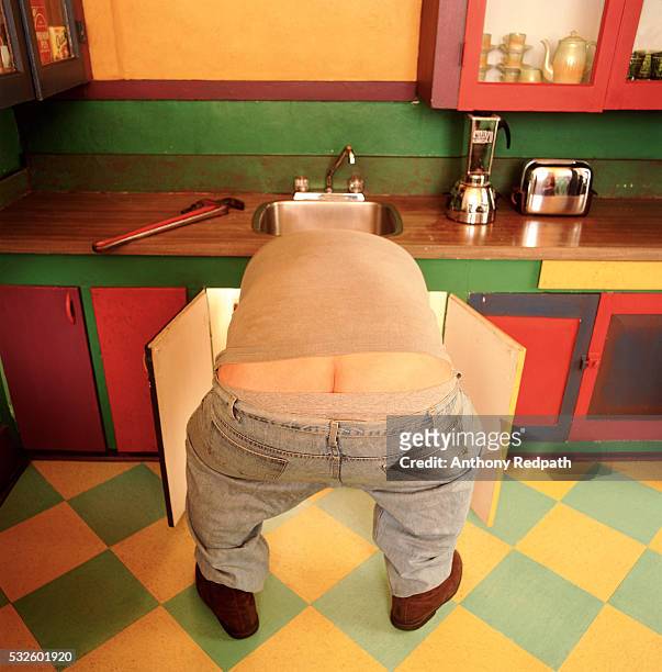 plumber with plumber's butt - work pants stock pictures, royalty-free photos & images