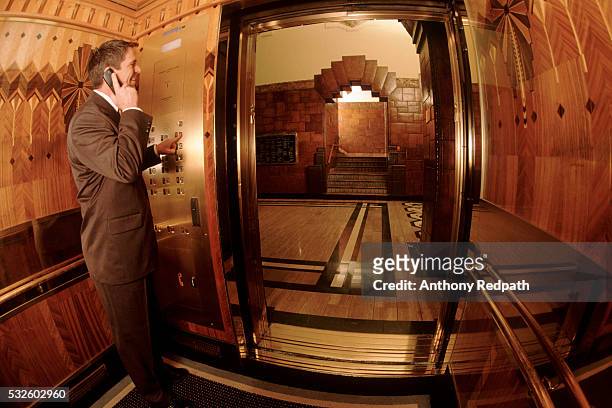 executive in an elevator - lift button stock pictures, royalty-free photos & images