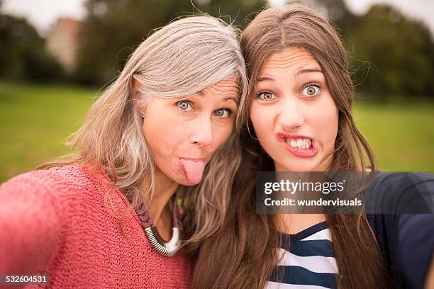 mother and daughter take selfie together - grimacing stock pictures, royalty-free photos & images