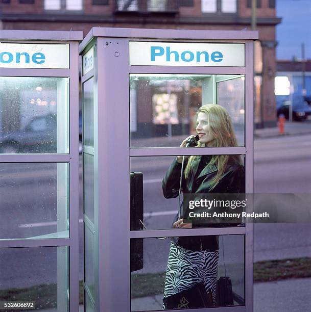 woman in a phone booth - telefonzelle stock-fotos und bilder