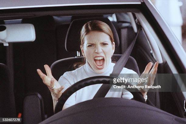 angry female driver - angry stock-fotos und bilder