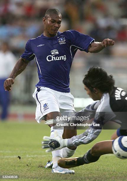 Marcus Bent of Everton scores their goal past Suree Sukha of Thailand during the FA Premier League Asia Trophy match between Thailand Under 23's and...