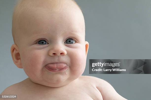 baby slobbering - funny baby faces stock pictures, royalty-free photos & images
