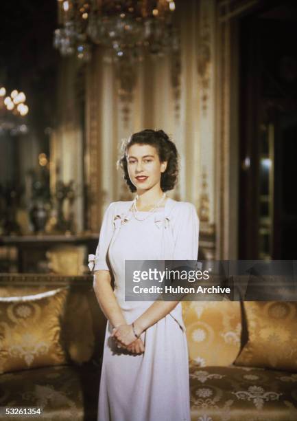 Princess Elizabeth, the future Queen Elizabeth II, in the state apartments at Buckingham Palace during her engagement to Prince Philip, Duke of...