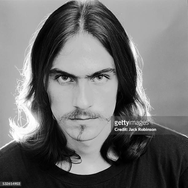 Headshot portrait of American folk musician James Taylor wearing a dark shirt, May 20, 1969.