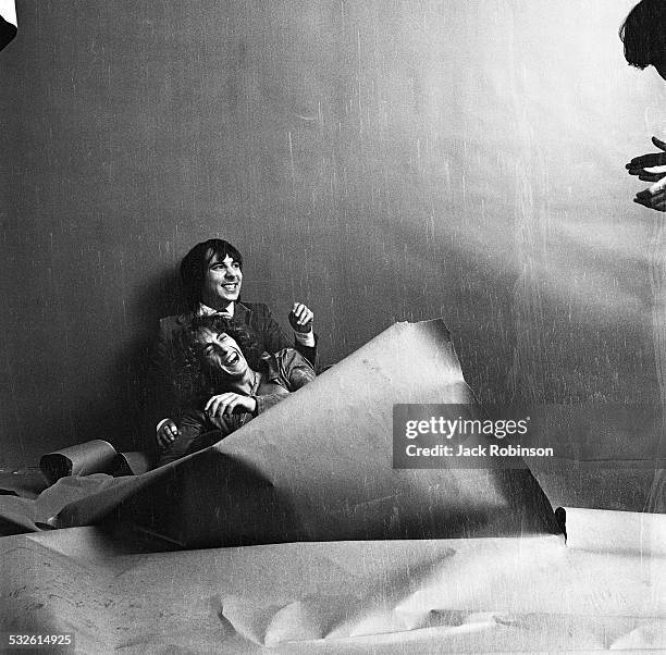 Portrait of British musicians Keith Moon and Roger Daltrey, both of the Who, as they laugh during a photo session, late 1960s or early 1970s.