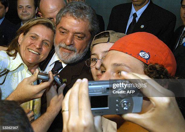 Brazil's President Luiz Inacio Lula da Silva poses with supporters in Recife, NE of Brazil, 20 July 2005. Despite the corruption crisis in his party,...