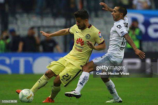 Jose Guerrero of America struggles for the ball with Edgar Castillo of Monterrey during the semi finals first leg match between America and Monterrey...