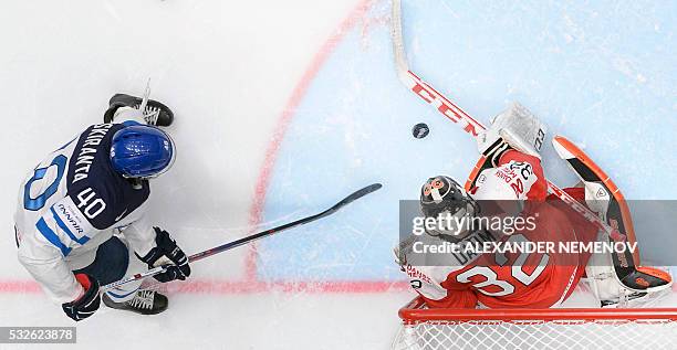 Finland's forward Jarno Koskiranta vies with Denmark's goalkeeper Sebastian Dahm during the quarter-final game Finland vs Denmark at the 2016 IIHF...