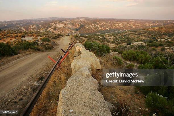 Line of granite boulders and railroad ties serves as a barrier to vehicles in a place where there is no solid US-Mexico border fence as citizen...