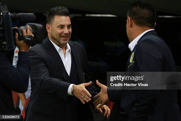 Antonio Mohamed coach of Monterrey greets Ignacio Ambriz coach of America prior the semi finals first leg match between America and Monterrey as part...