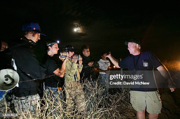 California Border Watch leader Jim Chase talks with camera-wielding activists protesting the nightly patrols by citizen volunteers who search for...