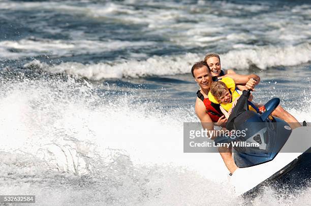family riding jet ski - jet ski stock pictures, royalty-free photos & images