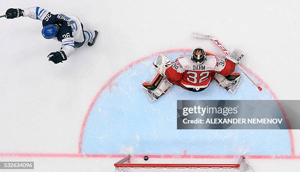 Finland's forward Jussi Jokinen celebrates a goal in front of Denmark's goalie Sebastian Dahm during the quarterfinal game Finland vs Denmark at the...