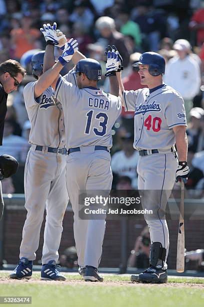 Infielder Alex Cora and catcher David Ross of the Los Angeles Dodgers celebrate at home plate during the game against the San Francisco Giants at SBC...