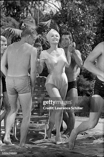 American actress Julie Newmar dances with various cast members in a scene from the film 'The Marriage-Go-Round' , Los Angeles, California, 1960.