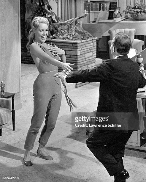 American actress Julie Newmar and British actor James Mason dance indoors in a scene from the film 'The Marriage-Go-Round' , Los Angeles, California,...