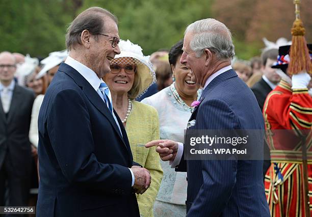 Prince Charles, Prince of Wales meets Sir Roger Moore during a garden party to mark the 40th anniversary of the Prince's Trust at Buckingham Palace...