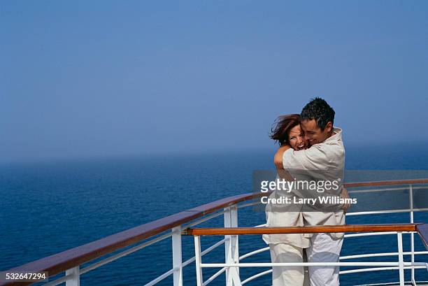 couple embracing on cruise ship deck - cruise deck stock pictures, royalty-free photos & images