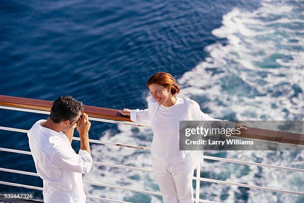 taking wife's picture on cruise ship deck - nave passeggeri foto e immagini stock