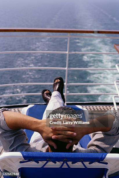 reclining on cruise ship deck - ponte di una nave foto e immagini stock
