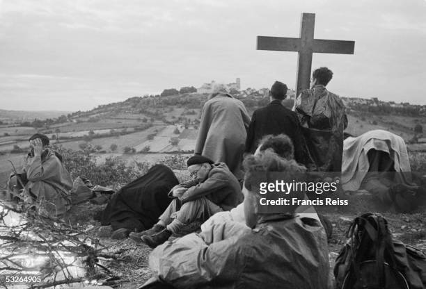 Group of British pilgrims walking through France set up their cross, for prayers at dusk, in sight of their destination, the Benedictine abbey at...