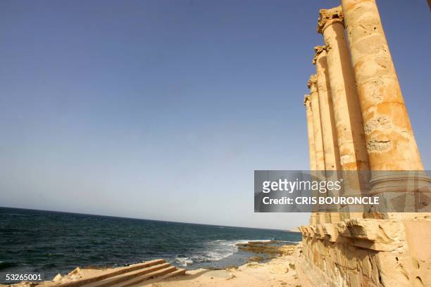 Columns from an ancient villa stand roofless against the Mediterranean Sea, part of the ruins of the Roman citadel of Sabratha, 67 kilometers west of...