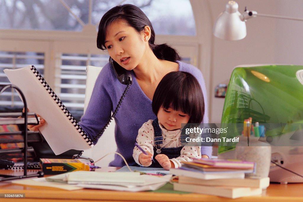 Mother and Daughter Sitting at Computer