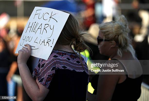 Supporter of Democratic presidential candidate Sen. Bernie Sanders holds an anti-Hillary Clinton sign during a campaign rally at Waterfront Park on...