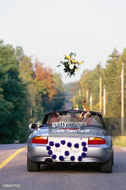 corporate newlyweds driving away - archival car stock pictures, royalty-free photos & images