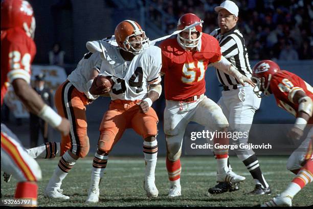 Running back Greg Pruitt of the Cleveland Browns has his jersey torn by linebacker Jim Lynch of the Kansas City Chiefs at Municipal Stadium on...