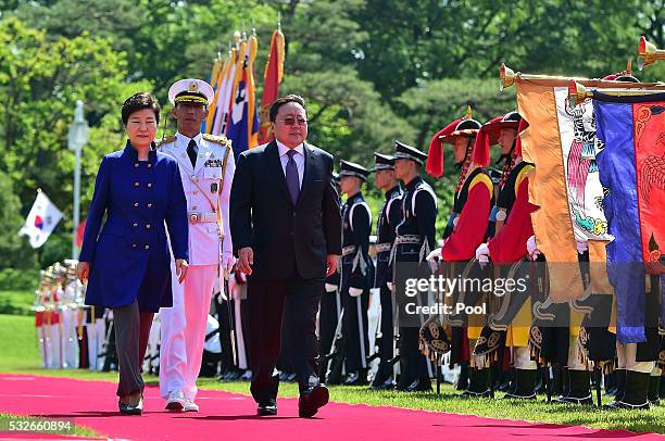 South Korean President Park Geun-Hye and Mongolian President Tsakhiagiin Elbegdorj inspect the honor guards during a welcoming ceremony at the...