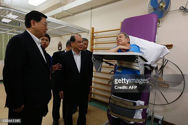 Zhang Dejiang , the chairman of China's National People's Congress, meets a man at an aged care complex in Hong Kong on May 19, 2016. Zhang Dejiang,...