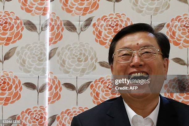 Zhang Dejiang, the chairman of China's National People's Congress, laughs during his visit to an aged care complex in Hong Kong on May 19, 2016....