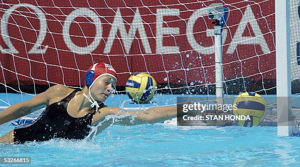 Hungary's goalkeeper Patricia Horvath stretches to block a shot by a Spainish player during a Women's preliminary Water Polo match 21 July, 2005 at...