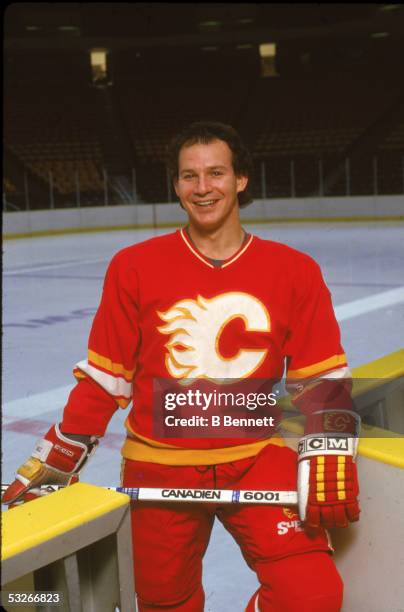 Portrait of American hockey player Joe Mullen of the Calgary Flames as he stands next to the boards, December 1987.