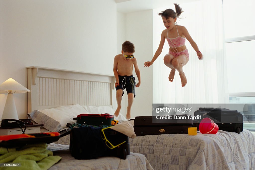 Children Jumping on Bed