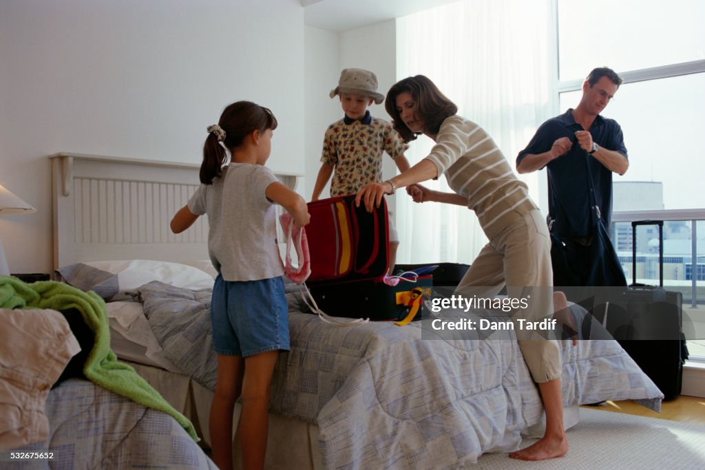 Family Unpacking in Hotel Room