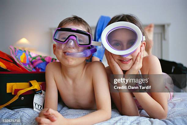 children on bed in snorkeling gear - vintage scuba mask stock pictures, royalty-free photos & images