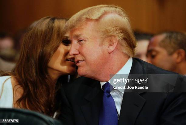 Donald Trump, president of the Trump Organization, talks with his wife Melania Trump prior to testifying before the Federal Financial Management,...