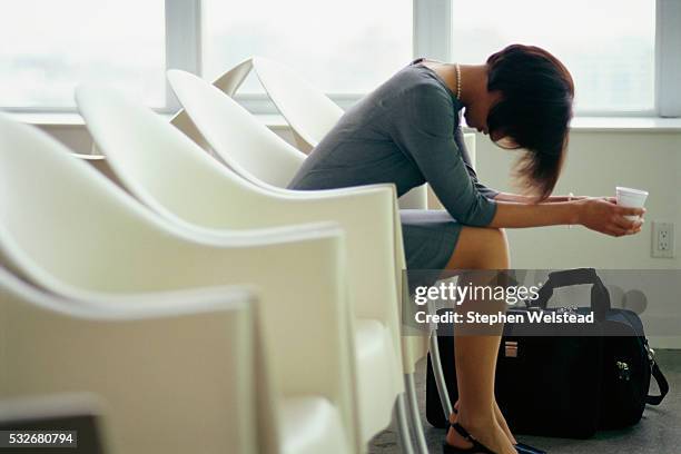 woman waiting at airport - impatient stock-fotos und bilder