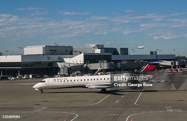 Delta Airlines regional jet prepares to pull into a Terminal A gate at Seattle-Tacoma International Airport on May 2 in Seattle, Washington. Seattle,...
