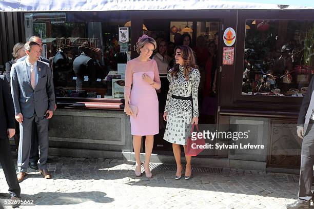 Queen Mathilde of Belgium and Queen Rania of Jordan pose for photographers after a visit to a chocolate shop during a royal guided tour through the...