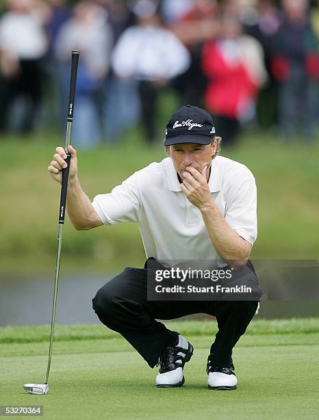 Bernhard Langer of Germany lines up his putt on the ninth hole during the delayed first round of The Deutsche Bank Players Championship on July 22,...