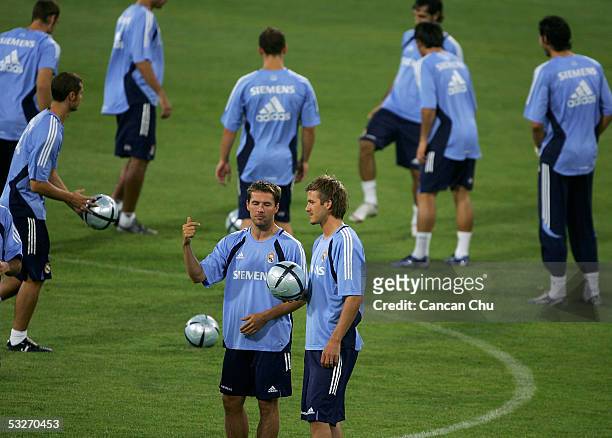 Real Madrid's David Beckham and Owen chat during a training session at the Teda Stadium on July 22, 2005 in Tianjin, China. Real Madrid is on a...