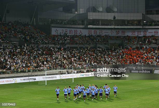 Players of the Real Madrid jog during a training session at the Teda Stadium on July 22, 2005 in Tianjin, China. Real Madrid are on a four-day visit...