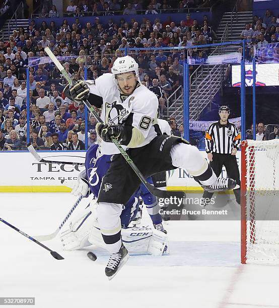 Sidney Crosby of the Pittsburgh Penguins jumps to avoid a shot against the Tampa Bay Lightning in Game Three of the Eastern Conference Final during...